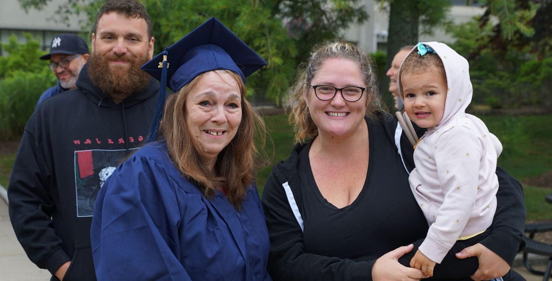 Family posing together at graduation ceremony